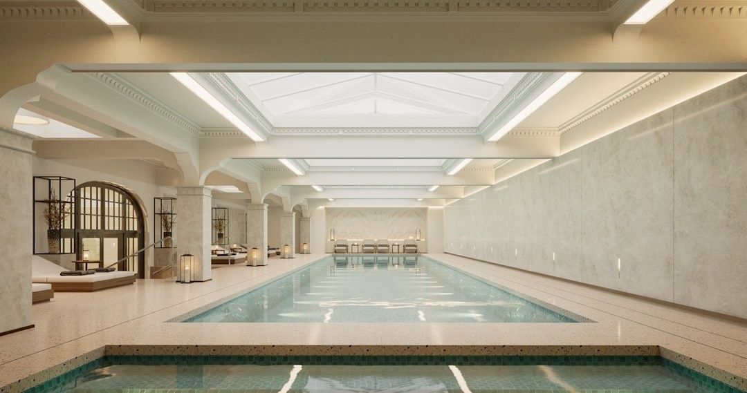 Elegant indoor spa pool with shallow steps and calm, reflective water