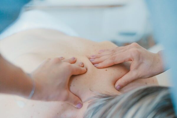 Close-up of hands performing a gentle massage on a person's back